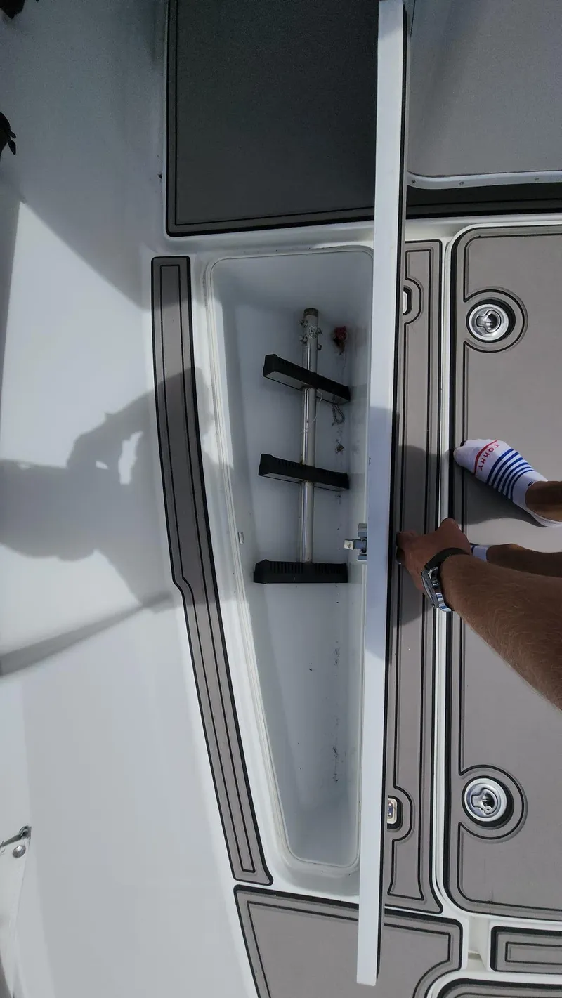 Slide: The Image of 2005 Yellowfin 31 boat storage compartment with open lid. - 28