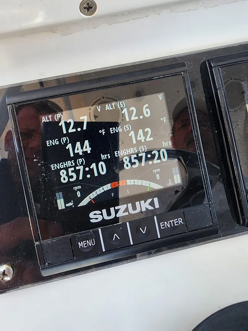Slide: The Image of Suzuki engine display on 2005 Yellowfin 31 boat, showing voltage and engine hours. - 29