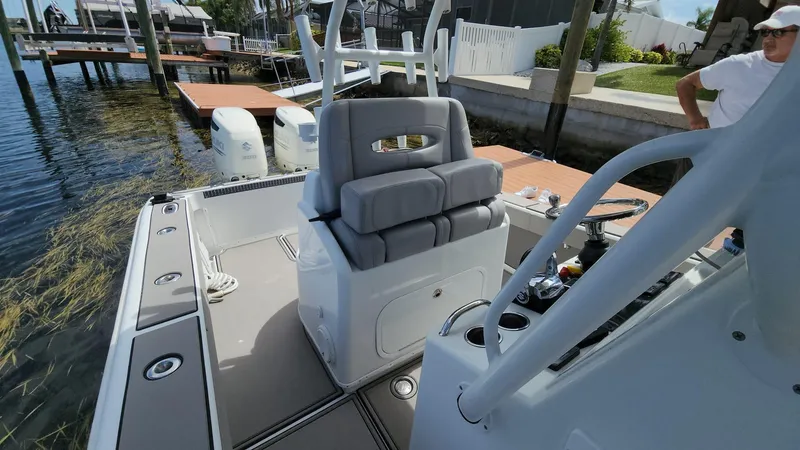 Slide: The Image of 2005 Yellowfin 31 boat interior with seating and controls, docked by the water. - 3
