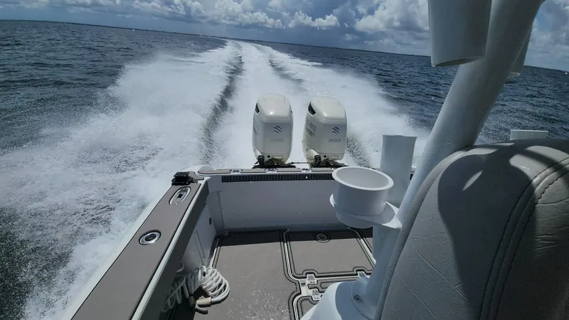 Slide: The Image of 2005 Yellowfin 31 boat cruising on open water, twin engines, leaving a wake. - 30