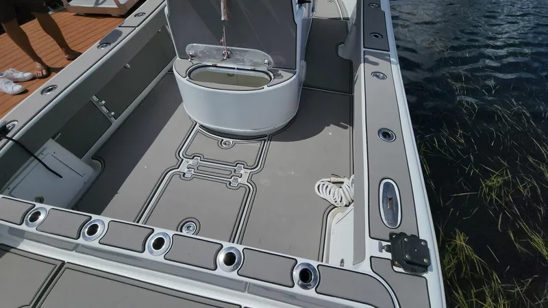 Slide: The Image of 2005 Yellowfin 31 boat deck with storage compartments and fishing rod holders. - 32