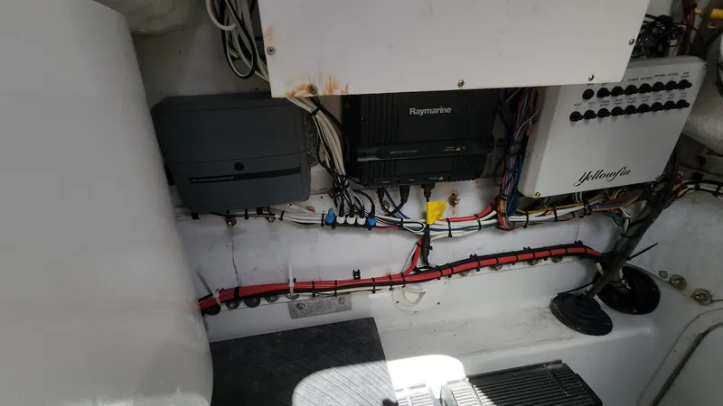 Slide: The Image of 2005 Yellowfin 31 boat electrical panel with wiring and equipment. - 33
