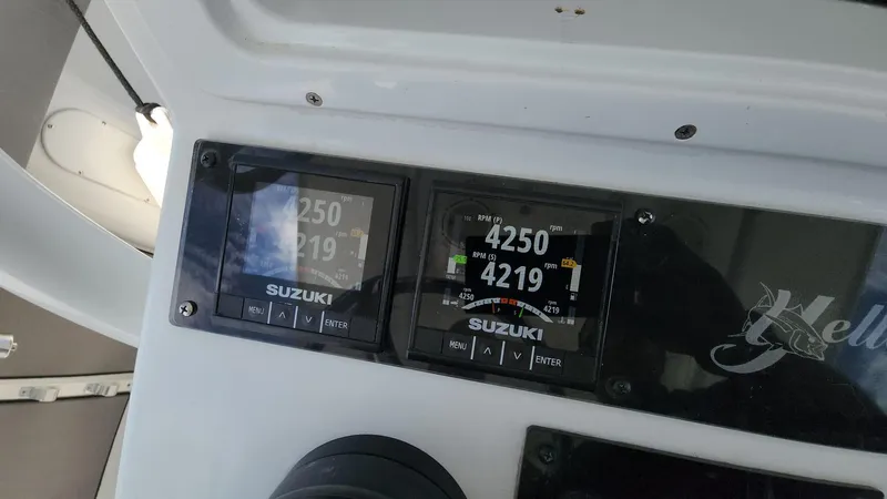 Slide: The Image of Suzuki engine displays on 2005 Yellowfin 31 boat dashboard. - 35