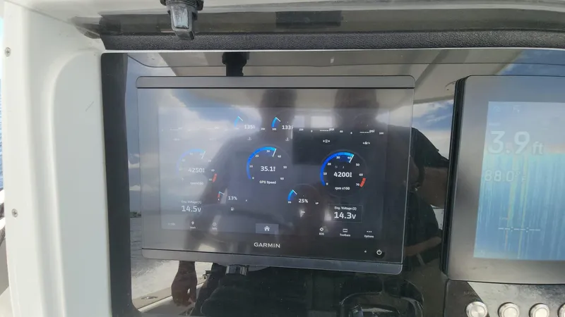 Slide: The Image of Garmin display on 2005 Yellowfin 31 boat dashboard showing navigation and engine data. - 40