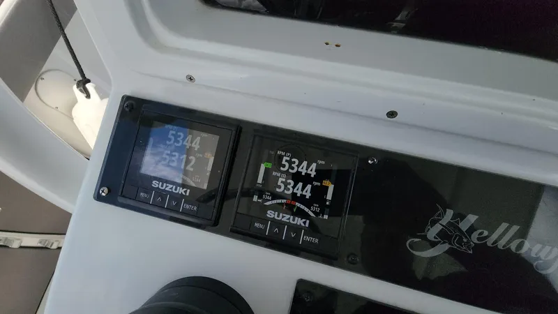 Slide: The Image of Dashboard of a 2005 Yellowfin 31 boat with Suzuki engine displays. - 42