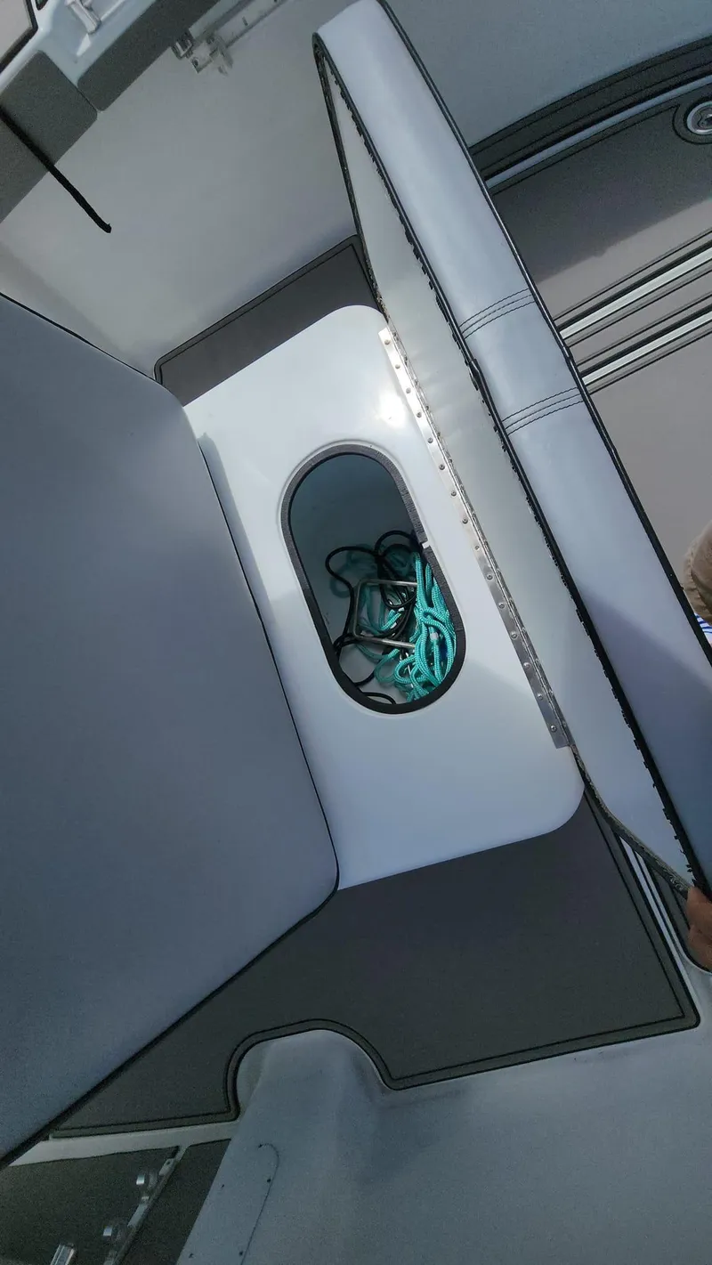 Slide: The Image of 2005 Yellowfin 31 boat storage compartment with ropes inside. - 44