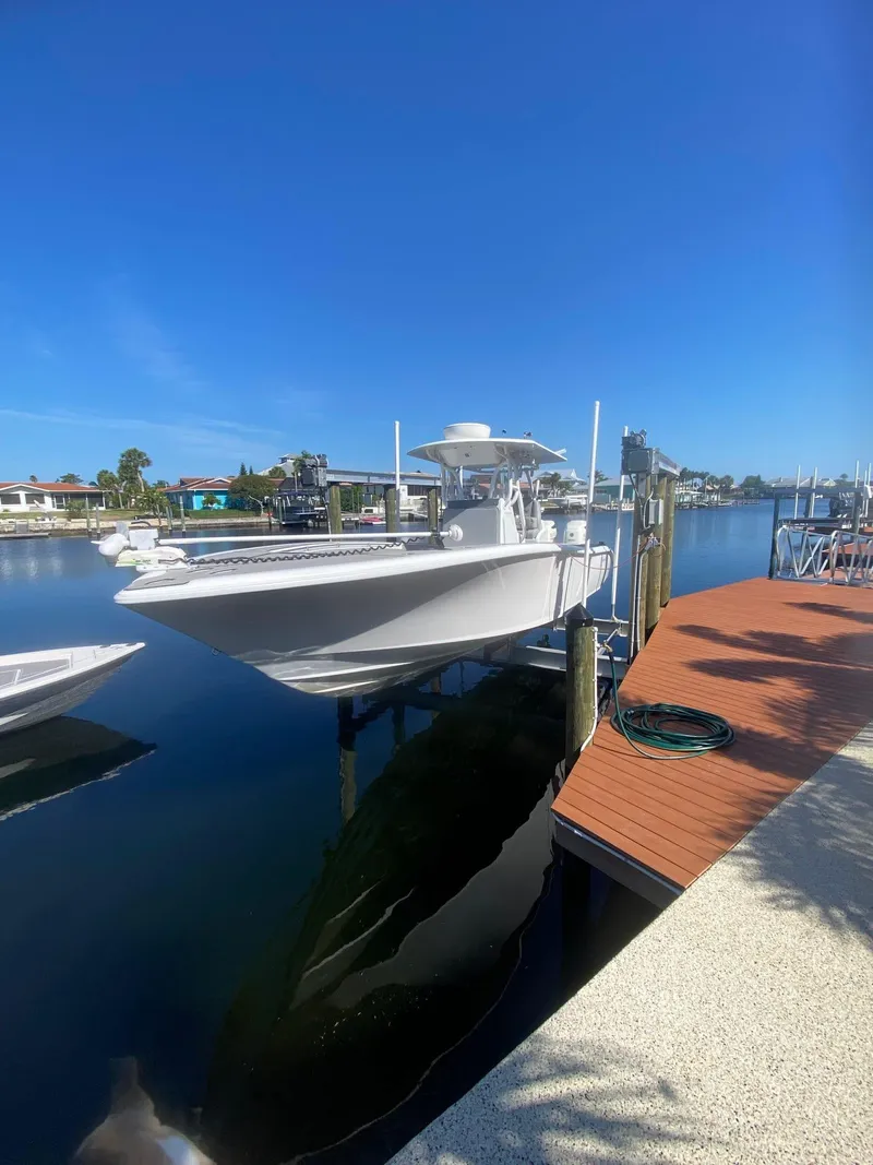 Slide: The Image of 2005 Yellowfin 31 boat docked on a sunny waterfront. - 9
