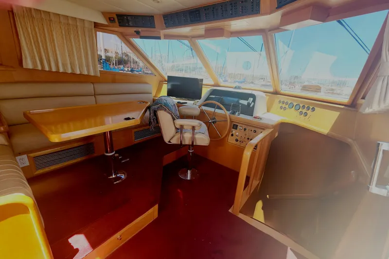 Slide: The Image of Interior of 1999 McKinna 57 Pilothouse yacht with helm and seating area. - 10