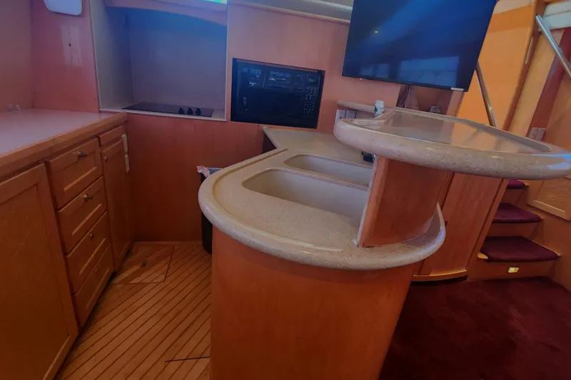 Slide: The Image of 1999 McKinna 57 Pilothouse interior with kitchen and bar area. - 11