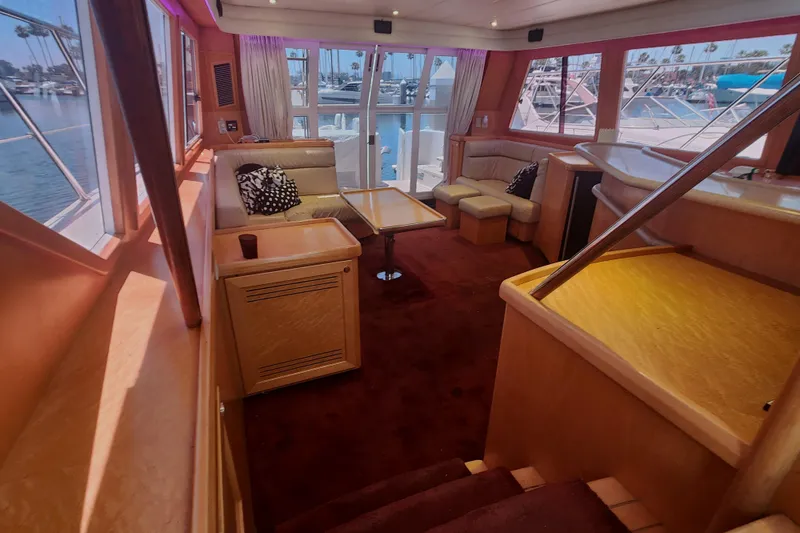 Slide: The Image of Luxurious interior of a 1999 McKinna 57 Pilothouse yacht with elegant seating and panoramic windows. - 12