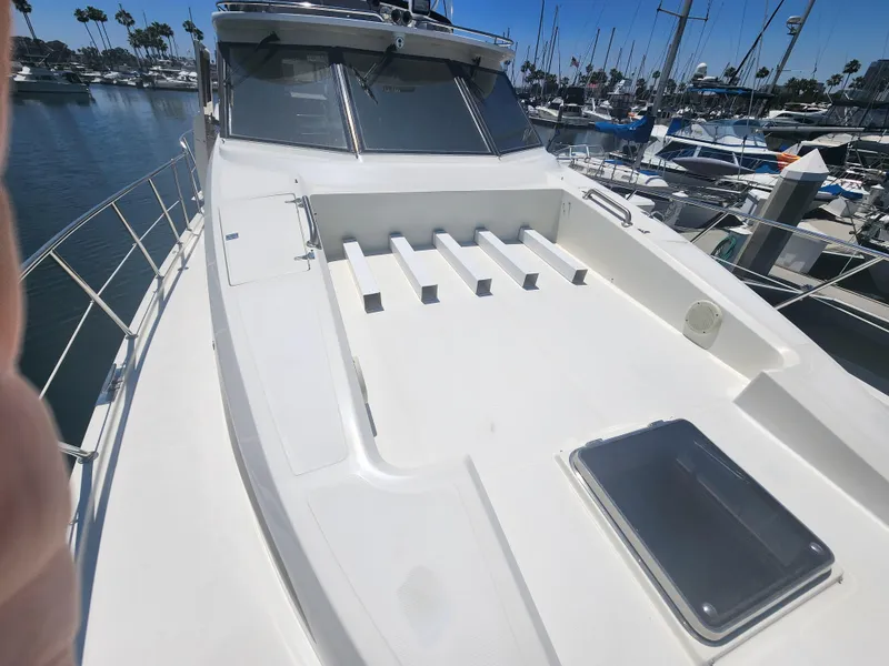 Slide: The Image of 1999 McKinna 57 Pilothouse yacht deck with marina background. - 19