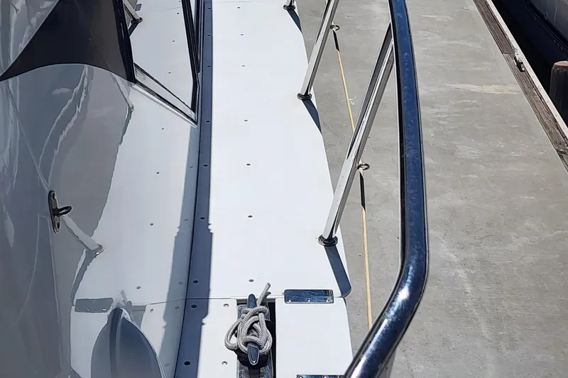 Slide: The Image of 1999 McKinna 57 Pilothouse yacht deck with railing and mooring line. - 20