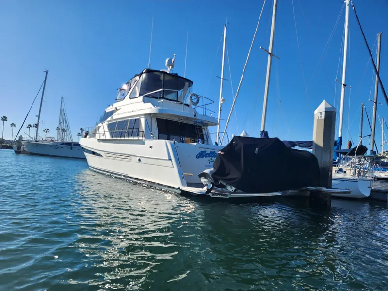 Slide: The Image of 1999 McKinna 57 Pilothouse yacht docked in a sunny marina. - 22