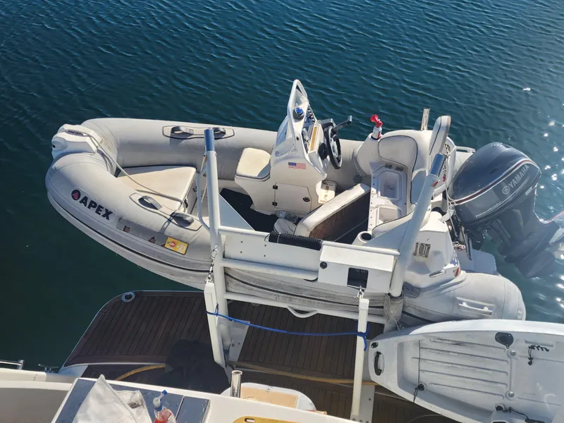 Slide: The Image of 1999 McKinna 57 Pilothouse with Apex inflatable boat on water. - 27