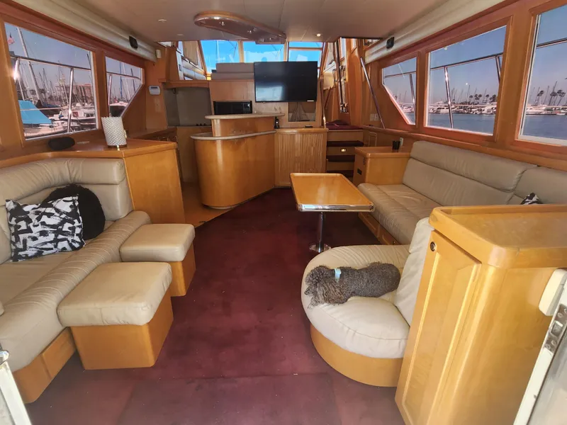 Slide: The Image of Luxurious interior of a 1999 McKinna 57 Pilothouse yacht with plush seating and large windows. - 3