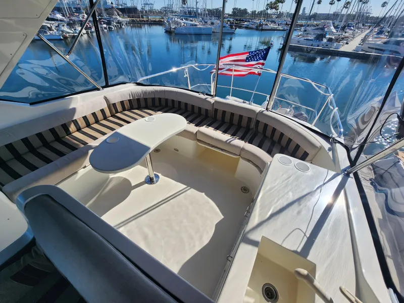 Slide: The Image of Luxurious 1999 McKinna 57 Pilothouse yacht with spacious seating and marina view. - 31