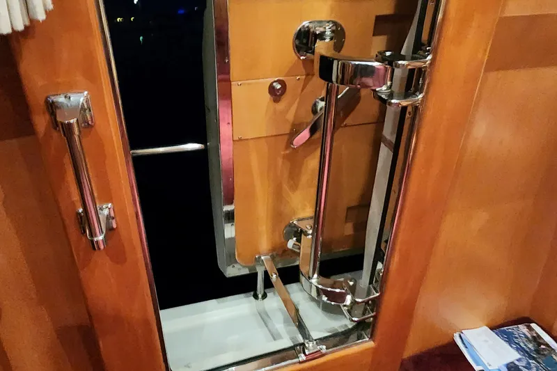 Slide: The Image of 1999 McKinna 57 Pilothouse interior door with chrome hardware and wooden finish. - 35