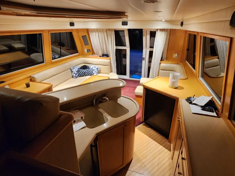 Slide: The Image of Luxurious interior of 1999 McKinna 57 Pilothouse yacht with elegant seating and modern amenities. - 36