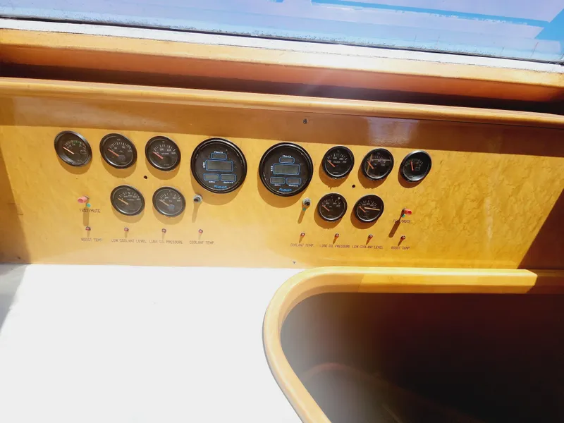 Slide: The Image of Control panel of a 1999 McKinna 57 Pilothouse yacht with various gauges and switches. - 6