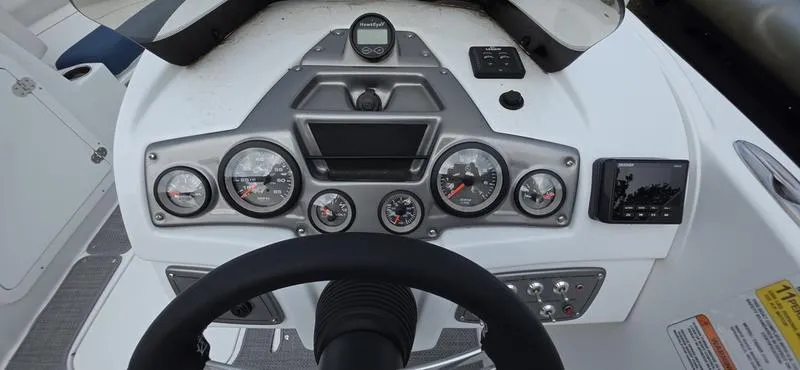 Slide: The Image of Dashboard of a 2024 Tahoe 2150 boat with gauges and controls. - 10