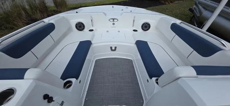 Slide: The Image of 2024 Tahoe 2150 boat interior with blue and white seating, spacious layout. - 11