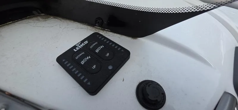 Slide: The Image of Control panel on 2024 Tahoe 2150 boat dashboard with Lenco trim tab buttons. - 13