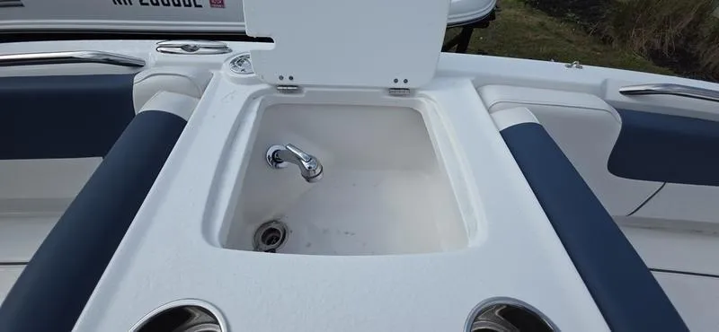 Slide: The Image of 2024 Tahoe 2150 boat sink with faucet and cup holders on deck. - 14