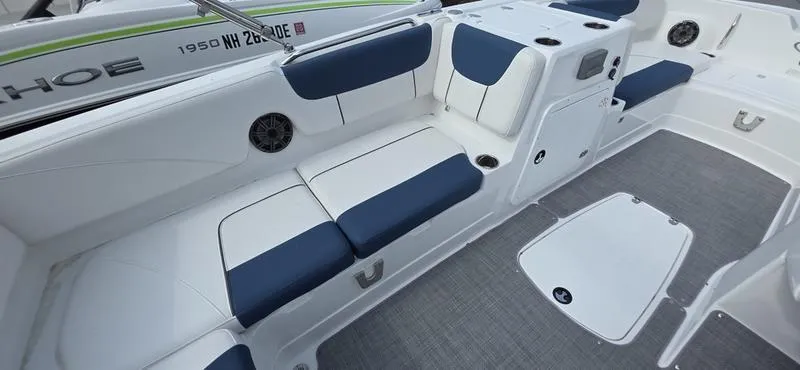 Slide: The Image of 2024 Tahoe 2150 boat interior with blue and white seating and modern design. - 16