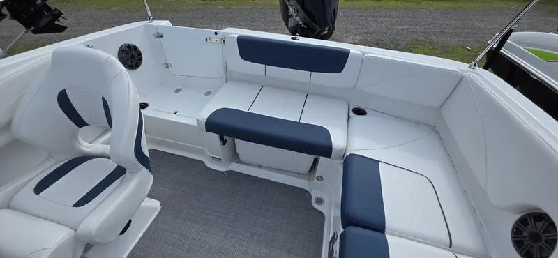 Slide: The Image of 2024 Tahoe 2150 boat interior with blue and white seating, spacious layout, and modern design. - 17