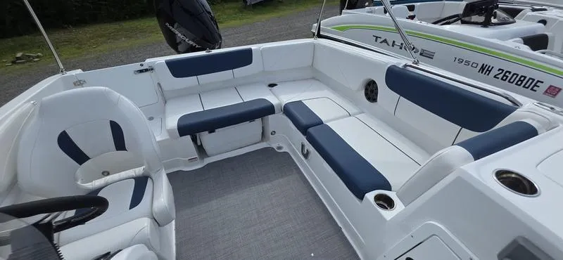 Slide: The Image of 2024 Tahoe 2150 boat interior with white and blue seating, spacious layout. - 8