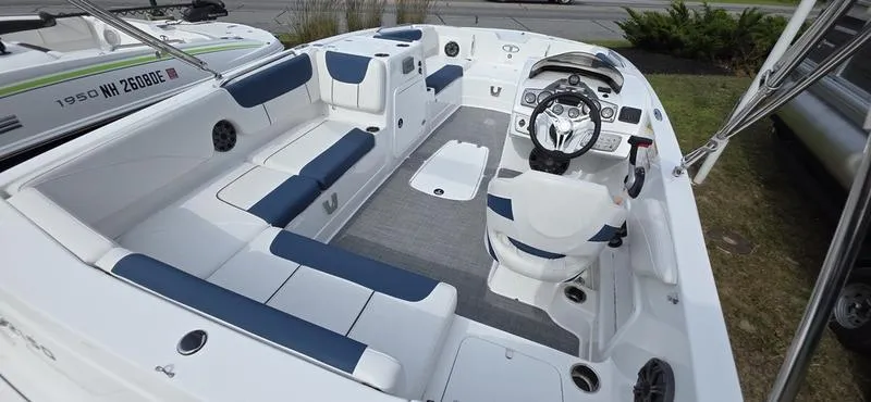 Slide: The Image of 2024 Tahoe 2150 boat interior with blue and white seating, modern dashboard, and spacious layout. - 9