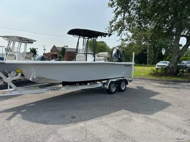 Slide: The Image of 2024 Savannah SS21 boat on a trailer in a parking lot. - 1