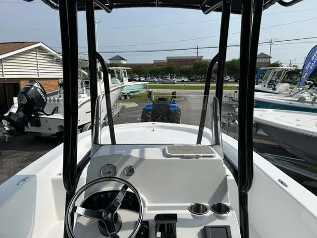 Slide: The Image of 2024 Savannah SS21 boat dashboard and steering wheel at a marina. - 13