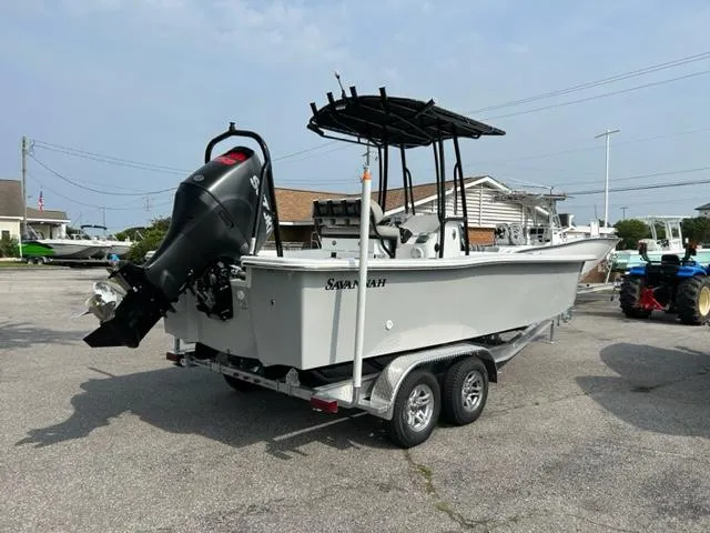 Slide: The Image of 2024 Savannah SS21 boat on a trailer with an outboard motor. - 2