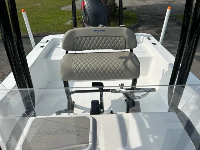 Slide: The Image of 2024 Savannah SS21 boat interior with cushioned seating and steering console. - 21