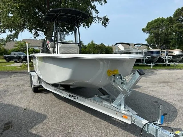 Slide: The Image of 2024 Savannah SS21 boat on a trailer in a parking lot. - 3