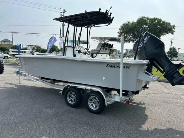 Slide: The Image of 2024 Savannah SS21 boat on a trailer with a powerful outboard motor. - 5