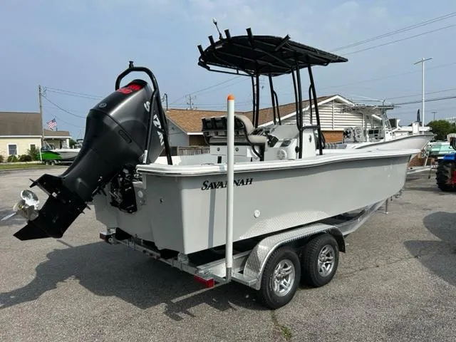 Slide: The Image of 2024 Savannah SS21 boat on a trailer with an outboard motor. - 11