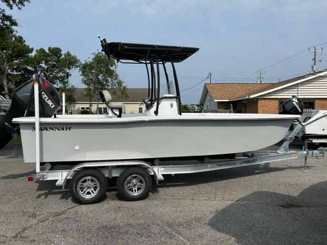 Slide: The Image of 2024 Savannah SS21 boat on a trailer in a parking lot. - 12