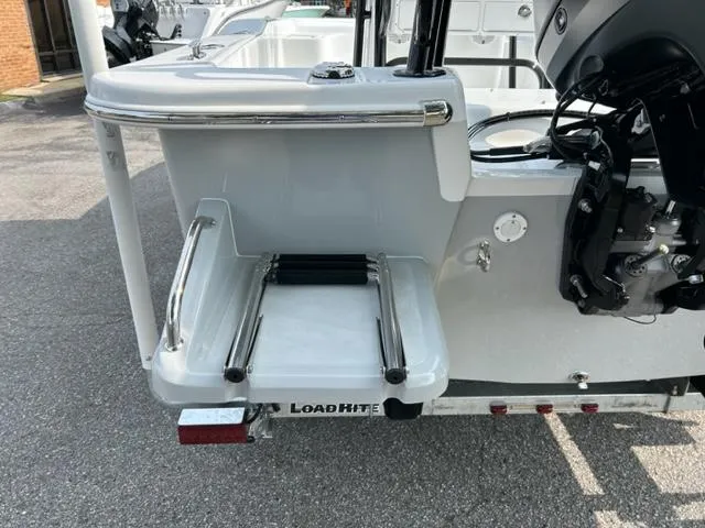 Slide: The Image of 2024 Savannah SS21 boat with Load Rite trailer, rear view showing swim platform and motor. - 9