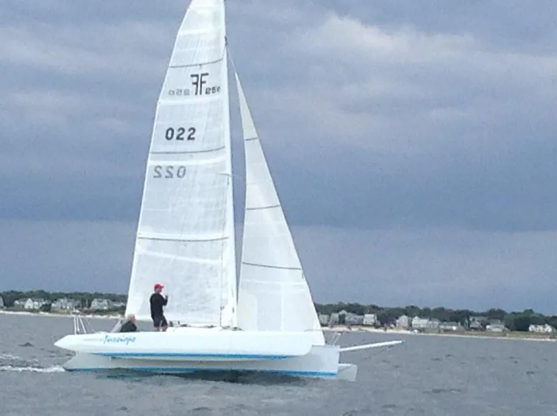 The Image of Sailing on a Farrier F-25C #22 trimaran, 2016 model, near a coastal town. - 0