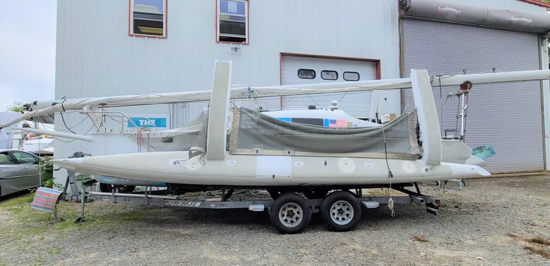 Slide: The Image of 2016 Farrier F-25C #22 trimaran on trailer, parked outside a building. - 1