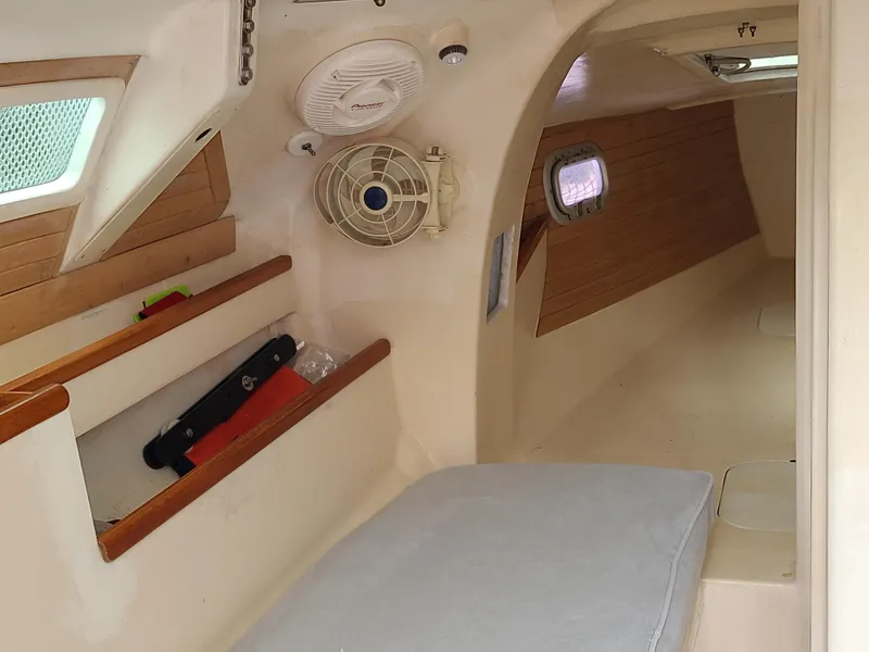 Slide: The Image of Interior of 2016 Farrier F-25C #22 sailboat, featuring cozy cabin and wooden accents. - 11