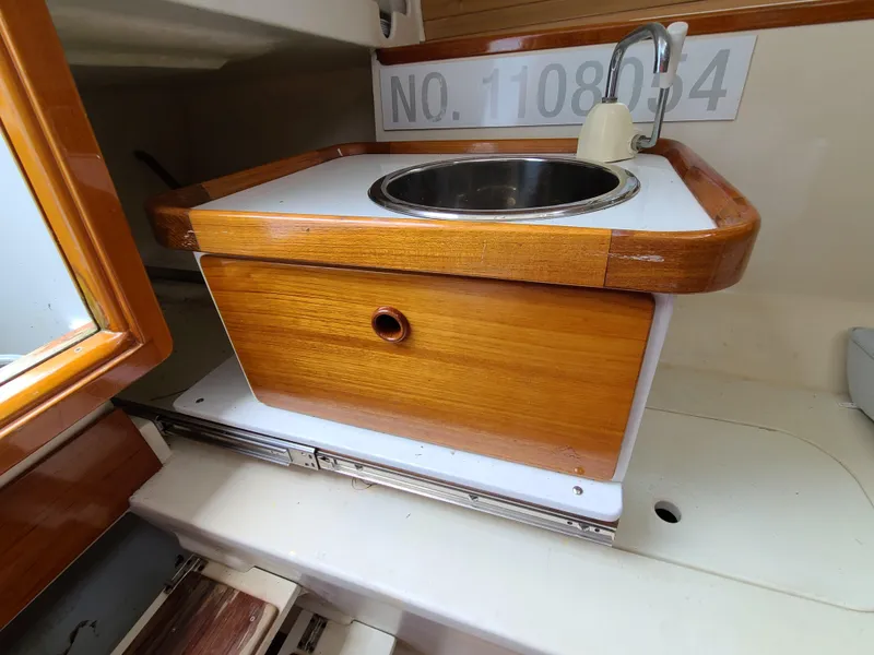 Slide: The Image of Compact wooden boat sink area in a 2016 Farrier F-25C #22. - 14