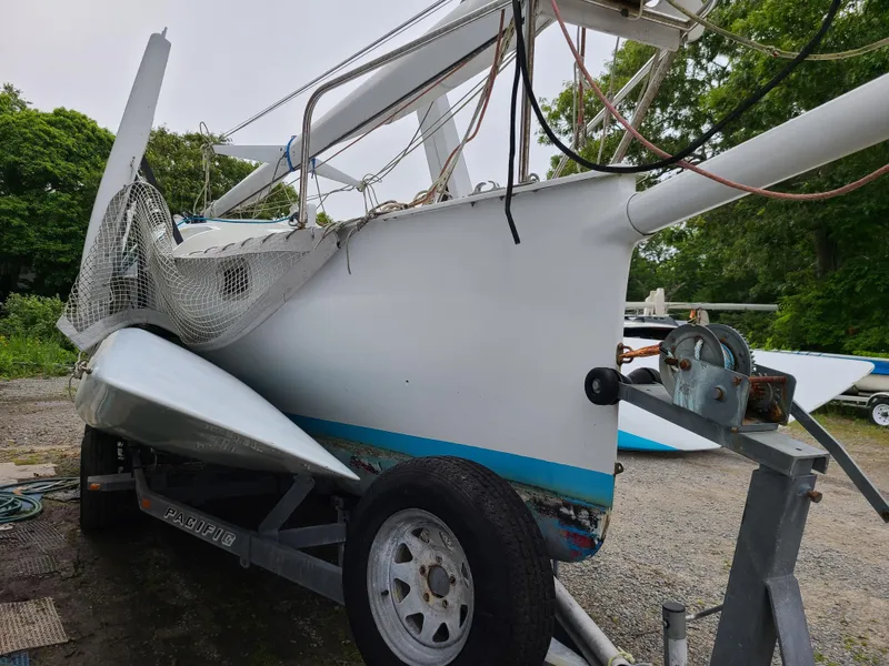 Slide: The Image of Farrier F-25C #22 trimaran sailboat on trailer, 2016 model, parked outdoors. - 3