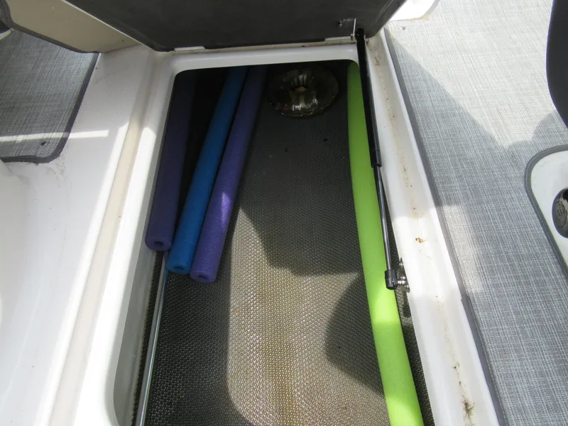 Slide: The Image of Storage compartment of a 2020 Vortex 203 VR boat with pool noodles. - 12