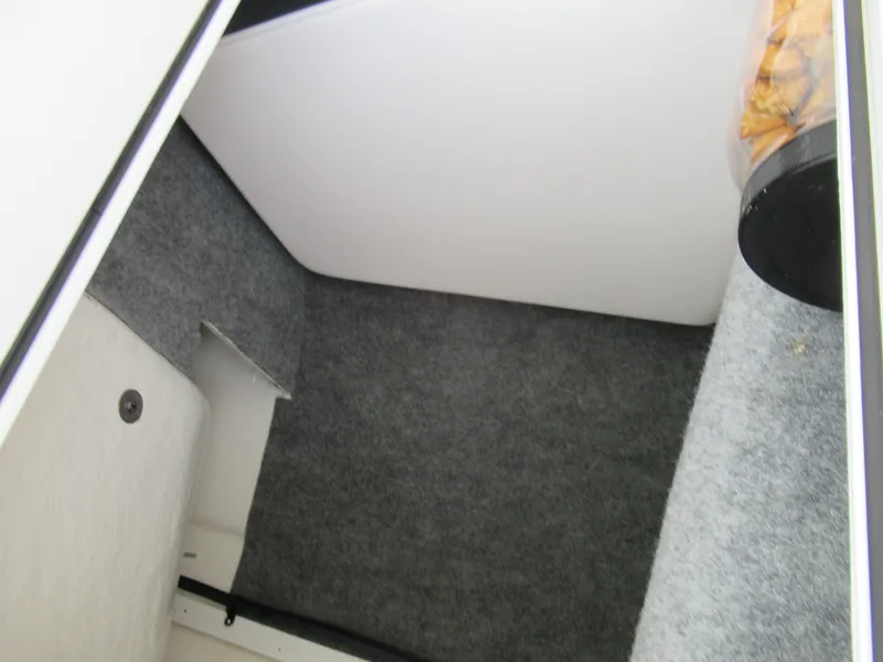 Slide: The Image of Interior storage compartment of 2020 Vortex 203 VR boat with grey carpeting. - 16