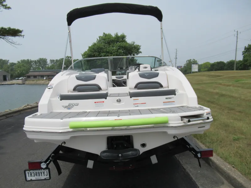 Slide: The Image of 2020 Vortex 203 VR boat on trailer, rear view near water. - 2