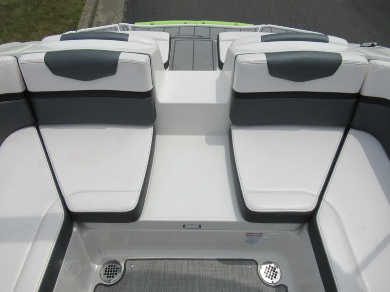 Slide: The Image of 2020 Vortex 203 VR boat interior seating area with white and gray cushions. - 23