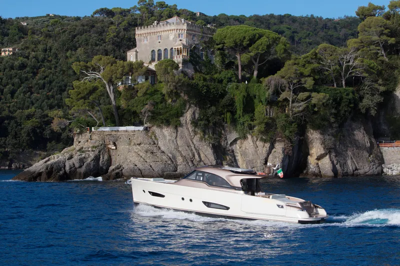 The Image of 2024 Solaris 57 Lobster yacht cruising near a scenic coastal villa. - 0